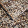 Load image into Gallery viewer, The Wildroot Rug folded to show layered texture and pattern, with visible purple and ash hues
